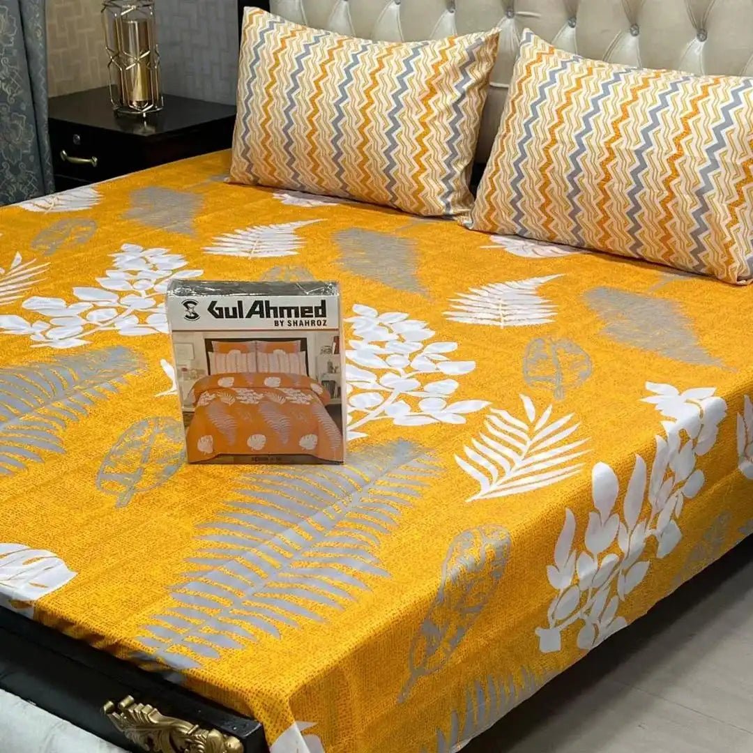 Bedspread with floral pattern and 'Kul Ahmed' packaging on a bed