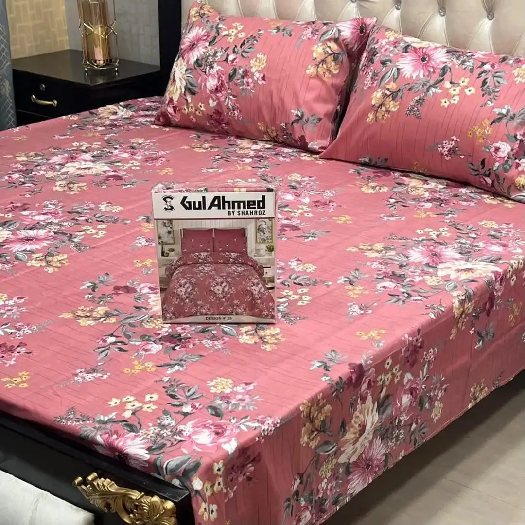 Floral bedsheet set on a bed with 'Gul Ahmed' branding.
