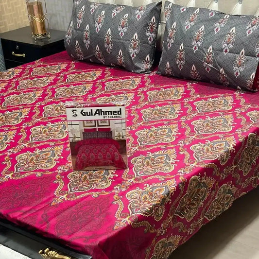 Decorative bedspread with intricate patterns on a bed, featuring Gul Ahmed branding.