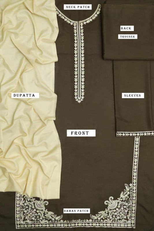 Brown fabric with white embroidery labeled for different parts of a garment.
