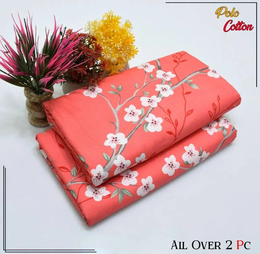 Coral fabric with floral pattern on a white background, featuring Polo Cotton branding.