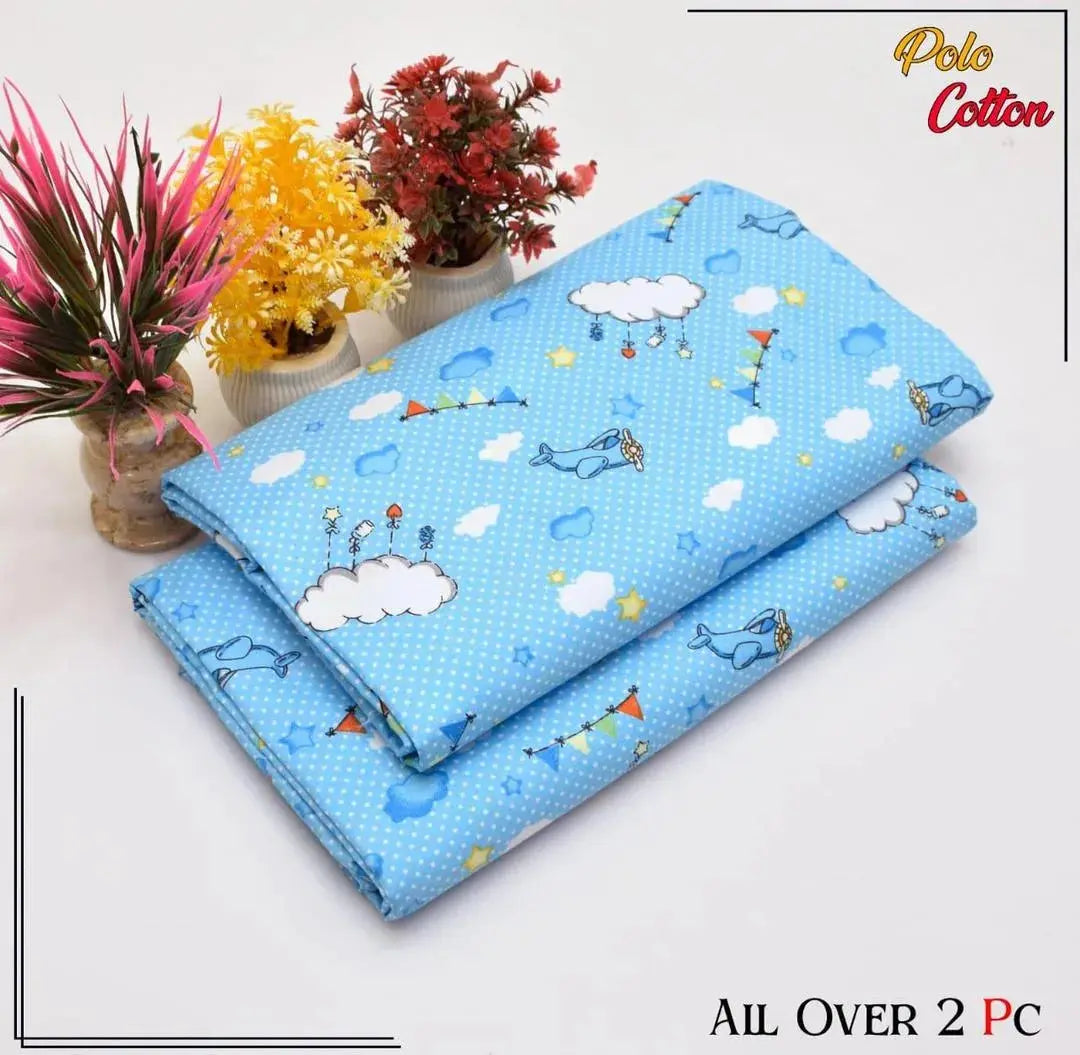 Blue children's quilt with cartoon designs on a white background, featuring the brand 'Polo Cotton'.