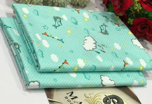 Two pieces of fabric with cartoon designs on a flat surface.
