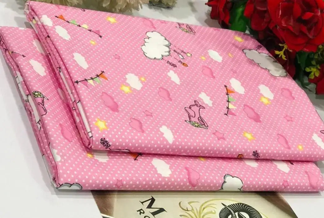 Pink fabric with cartoon designs on a white surface