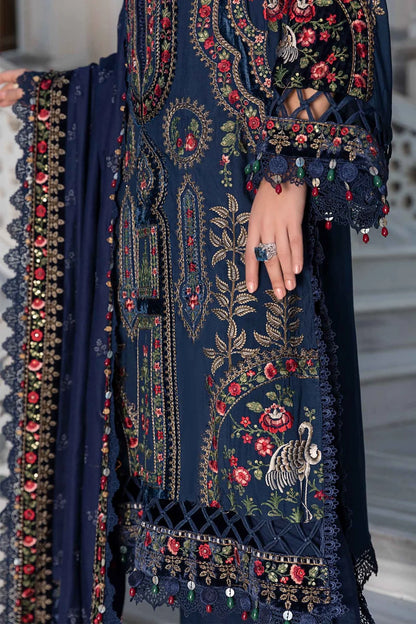 Navy blue embroidered garment with floral patterns and red accents.