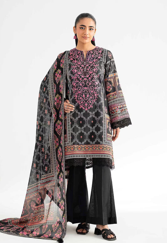 Woman wearing a traditional outfit with a black and pink embroidered dupatta on a white background