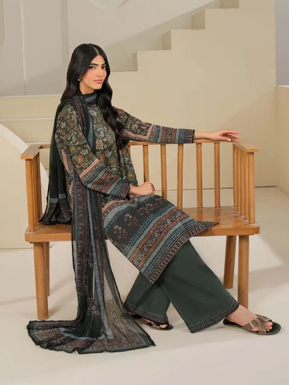 Woman in a patterned dress sitting on a wooden chair indoors.