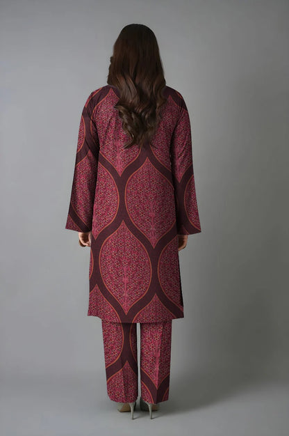 Person wearing a patterned outfit with a plain background