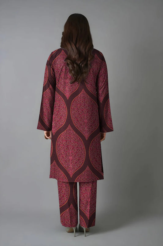 Person wearing a patterned outfit with a plain background